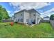 Spacious backyard with a well-maintained lawn, patio with furniture, and a fire pit area, perfect for outdoor entertaining at 166 Glenn Allen Rd, Mooresville, NC 28115