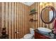 Charming powder room with decorative wallpaper, a pedestal sink, and elegant accents at 166 Glenn Allen Rd, Mooresville, NC 28115