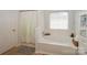 Elegant bathroom featuring a soaking tub, white cabinetry, and stylish decor at 166 Glenn Allen Rd, Mooresville, NC 28115