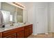 Bright bathroom featuring a dual sink vanity, tiled floors, and a large mirror at 166 Glenn Allen Rd, Mooresville, NC 28115