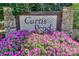 Stone community sign for Curtis Pond surrounded by vibrant flowers, offering a welcoming entrance to the neighborhood at 166 Glenn Allen Rd, Mooresville, NC 28115