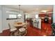 Bright dining area with wood floors and stainless steel appliances in the kitchen at 166 Glenn Allen Rd, Mooresville, NC 28115