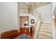 Spacious foyer featuring hardwood floors, white staircase and views into the living room at 166 Glenn Allen Rd, Mooresville, NC 28115