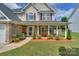 Charming house exterior featuring a cozy front porch and colorful flower beds at 166 Glenn Allen Rd, Mooresville, NC 28115