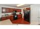 Kitchen with dark cabinets, updated appliances, and neutral countertops at 166 Glenn Allen Rd, Mooresville, NC 28115