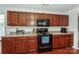 Kitchen with dark cabinets, updated appliances, and neutral countertops at 166 Glenn Allen Rd, Mooresville, NC 28115