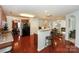 Open-concept kitchen with bar, stainless steel refrigerator, and wood floors at 166 Glenn Allen Rd, Mooresville, NC 28115