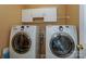 Bright laundry room featuring a modern washer and dryer set and upper cabinets for ample storage at 166 Glenn Allen Rd, Mooresville, NC 28115