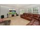 Spacious living room featuring plush seating, neutral carpet, and a large television for entertainment at 166 Glenn Allen Rd, Mooresville, NC 28115