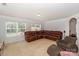 Living room with carpet, neutral walls, and large leather couch at 166 Glenn Allen Rd, Mooresville, NC 28115