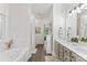 Bright bathroom featuring a double vanity, soaking tub and tiled walk-in shower at 1730 Eden Glen Dr, Dallas, NC 28034
