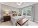 Comfortable bedroom featuring a queen bed, bedside tables, lamps, and a window with a view of the greenery at 1730 Eden Glen Dr, Dallas, NC 28034