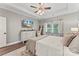 A light filled bedroom showcasing a TV, a window, a crib and hardwood floors at 1730 Eden Glen Dr, Dallas, NC 28034