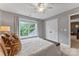 Bright bedroom with a queen bed, ceiling fan, and large window overlooking the outdoors at 1730 Eden Glen Dr, Dallas, NC 28034
