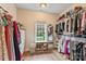 Walk-in closet with ample storage space, organized shelving, and natural light from a window at 1730 Eden Glen Dr, Dallas, NC 28034