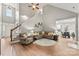 Bright living room with high ceilings, hardwood floors, a cozy sectional, and an open view of the dining area at 1730 Eden Glen Dr, Dallas, NC 28034