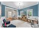 A versatile playroom with built-in storage, natural light and a calming blue color palette at 1730 Eden Glen Dr, Dallas, NC 28034