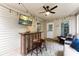 Covered back porch featuring string lights, a ceiling fan, mounted TV, and comfortable seating at 1730 Eden Glen Dr, Dallas, NC 28034