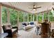 Inviting screened porch with comfortable seating, ceiling fan, and views of the wooded backyard at 1730 Eden Glen Dr, Dallas, NC 28034