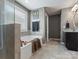 Bathroom featuring a soaking tub, tiled shower with glass door, and neutral gray paint at 1810 Kerwick Ct, Lancaster, SC 29720