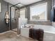 Bathroom featuring a soaking tub, tiled shower with glass door, and neutral gray wall paint at 1810 Kerwick Ct, Lancaster, SC 29720