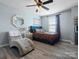 Bright bedroom featuring wood floors, a comfy chaise lounge, and a window for natural light at 1810 Kerwick Ct, Lancaster, SC 29720