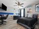 Bedroom with laminate floors, a ceiling fan, a black bed, and a desk with a gaming chair at 1810 Kerwick Ct, Lancaster, SC 29720