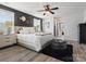 A primary bedroom featuring a tufted headboard bed, modern nightstands, stylish decor, and wood-look flooring at 1810 Kerwick Ct, Lancaster, SC 29720