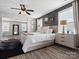 Primary bedroom with tufted headboard bed, modern nightstands, stylish decor and wood-look flooring at 1810 Kerwick Ct, Lancaster, SC 29720