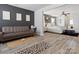 Open layout of a bedroom and living area featuring dark accent wall, stylish furniture and wood-look floors at 1810 Kerwick Ct, Lancaster, SC 29720