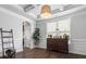 Bright dining room features hardwood floors, elegant trim, and a large window, creating an ideal space for meals at 1810 Kerwick Ct, Lancaster, SC 29720