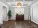 Elegant dining room boasts hardwood floors, white trim, a large window, and ample natural light at 1810 Kerwick Ct, Lancaster, SC 29720