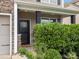 Charming front entrance is framed by stone accents and lush greenery, offering a warm and inviting welcome at 1810 Kerwick Ct, Lancaster, SC 29720