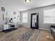 Bright home gym with light gray walls, wood-look floors, a large mirror and natural light from two windows at 1810 Kerwick Ct, Lancaster, SC 29720