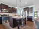 Well-lit kitchen with stainless steel appliances, wooden cabinets, and an island with barstool seating at 1810 Kerwick Ct, Lancaster, SC 29720