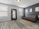 Seating area featuring wood floors, a gray and black wall, and a cozy leather sofa at 1810 Kerwick Ct, Lancaster, SC 29720
