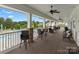 A covered patio boasts ample seating with a view of the lush landscaping and sparkling pool at 1810 Kerwick Ct, Lancaster, SC 29720