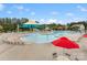 A swimming pool area features lounge chairs, shade structures, and a splash area for  at 1810 Kerwick Ct, Lancaster, SC 29720