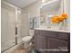 Bathroom featuring a glass shower, wood-look flooring, and a vanity with a stone countertop at 205 Cliffwood Nw St # A-1, Concord, NC 28027