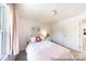 Charming bedroom with natural light, a decorative flower pillow and simple decor at 205 Cliffwood Nw St # A-1, Concord, NC 28027
