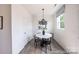Bright dining area features a round table with modern pendant lighting and a window at 205 Cliffwood Nw St # A-1, Concord, NC 28027