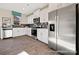 Kitchen featuring stainless steel appliances, white cabinets, stone countertops and a tile backsplash at 205 Cliffwood Nw St # A-1, Concord, NC 28027