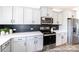 Contemporary kitchen equipped with sleek appliances, white countertops, and a stylish black backsplash at 205 Cliffwood Nw St # A-1, Concord, NC 28027