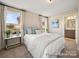 Bright main bedroom with two windows and a view into the main bath with a double vanity at 205 Cliffwood Nw St # A-1, Concord, NC 28027