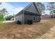 Side view of a grey house with a garage and unfinished backyard at 209 Stafford Estates Dr, Salisbury, NC 28146