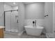 Elegant bathroom featuring a freestanding tub and walk-in shower, creating a serene spa-like experience at 209 Stafford Estates Dr, Salisbury, NC 28146