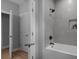 Modern bathroom features a white tub, tiled shower, and contemporary fixtures for a relaxing experience at 209 Stafford Estates Dr, Salisbury, NC 28146