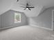 Cozy bedroom with neutral paint, plush carpet, a ceiling fan and a window with natural light at 209 Stafford Estates Dr, Salisbury, NC 28146