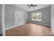 Bright bedroom featuring neutral walls, wood flooring, ceiling fan, and a double door closet at 209 Stafford Estates Dr, Salisbury, NC 28146