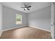 Cozy bedroom features a ceiling fan, window, and plank flooring at 209 Stafford Estates Dr, Salisbury, NC 28146